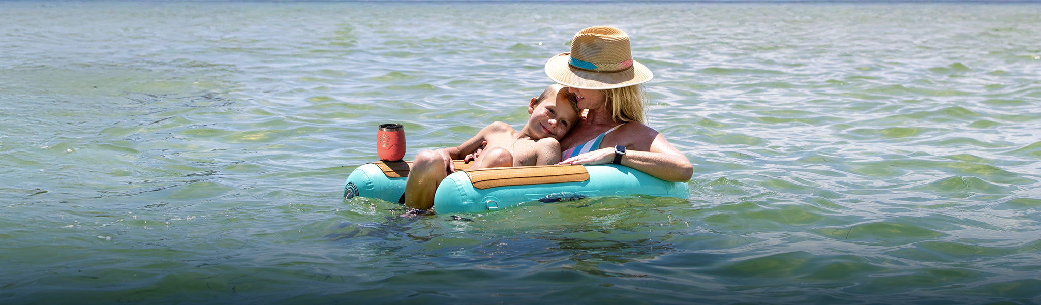 A mom sitting in a sling chair with son