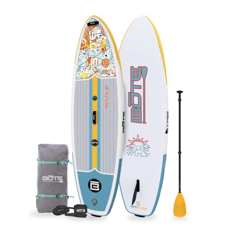 Angled view of the WULF Aero 10'4" Native Coral Inflatable Paddle Board with travel bag, leash, and paddle