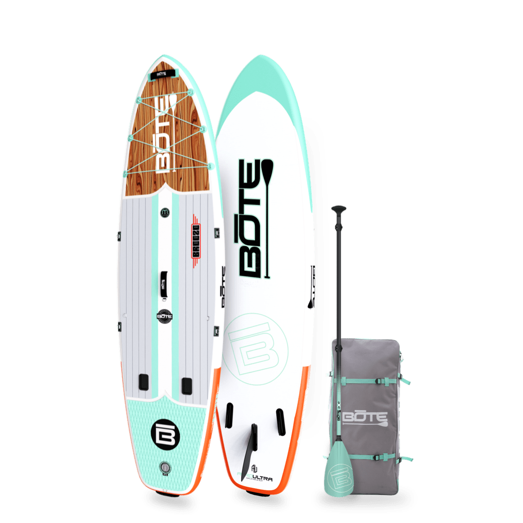 Angled view of the 10'6" Breeze Aero Classic Mangrove inflatable paddle board with bag and paddle