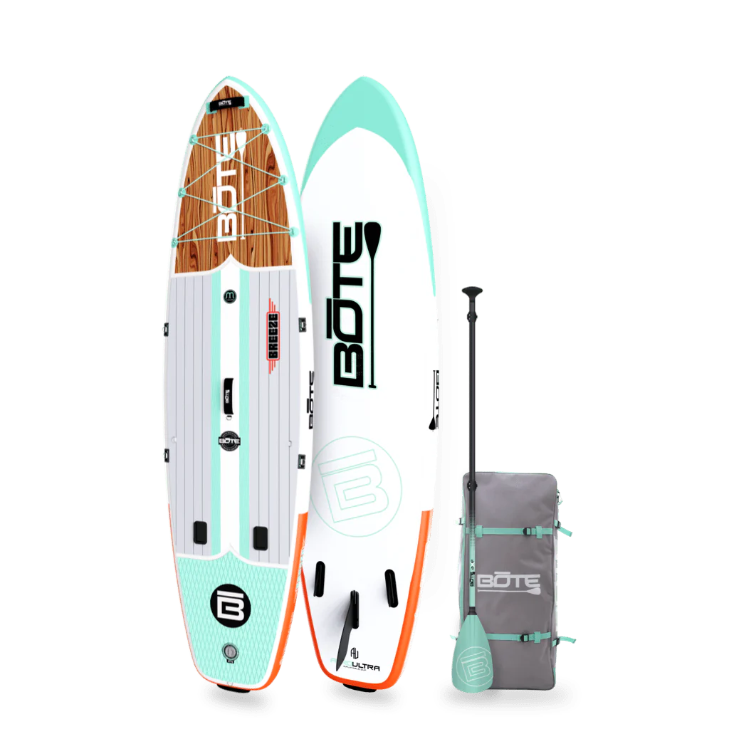 Angled view of the 10'6" Breeze Aero Classic Mangrove inflatable paddle board with bag and paddle
