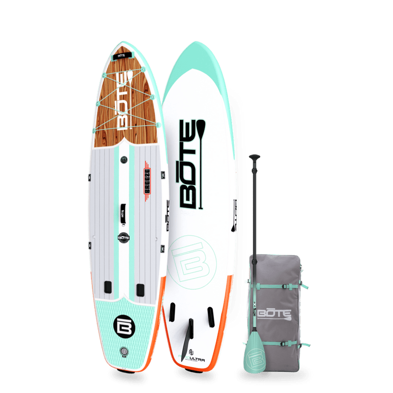 Angled view of the 10'6" Breeze Aero Classic Mangrove inflatable paddle board with bag and paddle