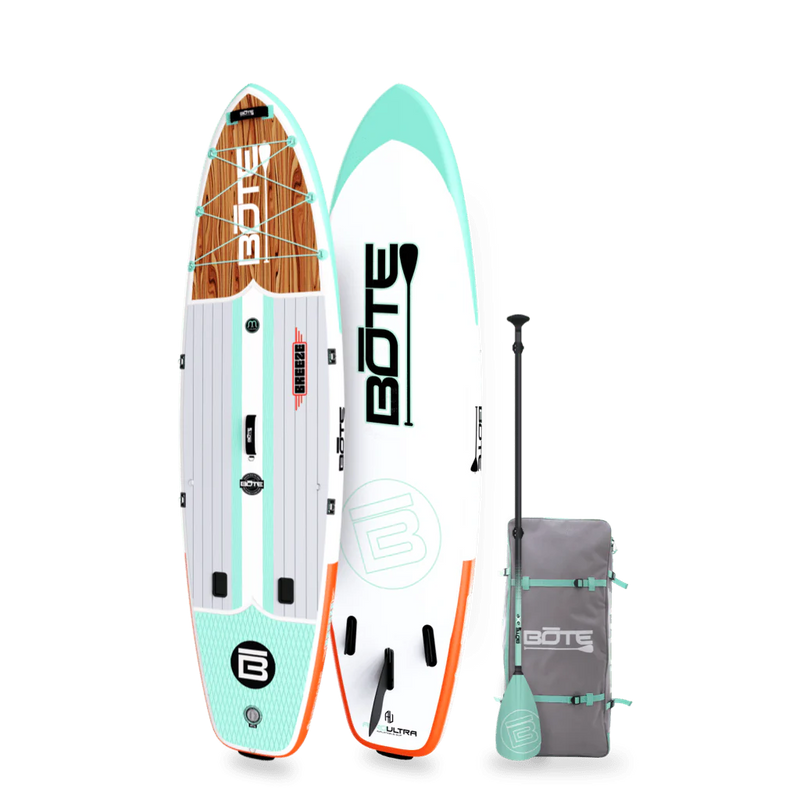 Angled view of the 10'6" Breeze Aero Classic Mangrove inflatable paddle board with bag and paddle