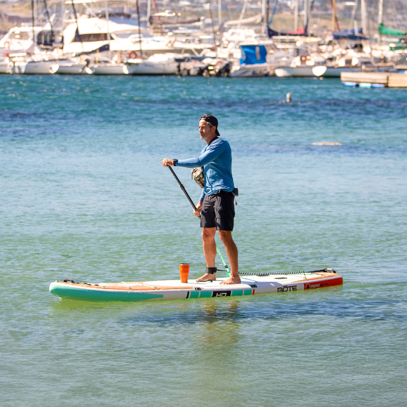 Lifestyle view of a guy paddling on the HD Aero 11′6″ Classic Mangrove Inflatable Paddle Board