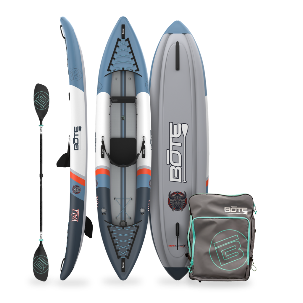 Inflatable kayak with paddle and carrying bag on a white background