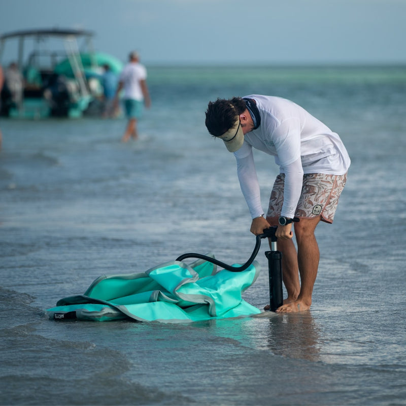 Man pumping up the Inflatable AeroRondak® Chair Classic