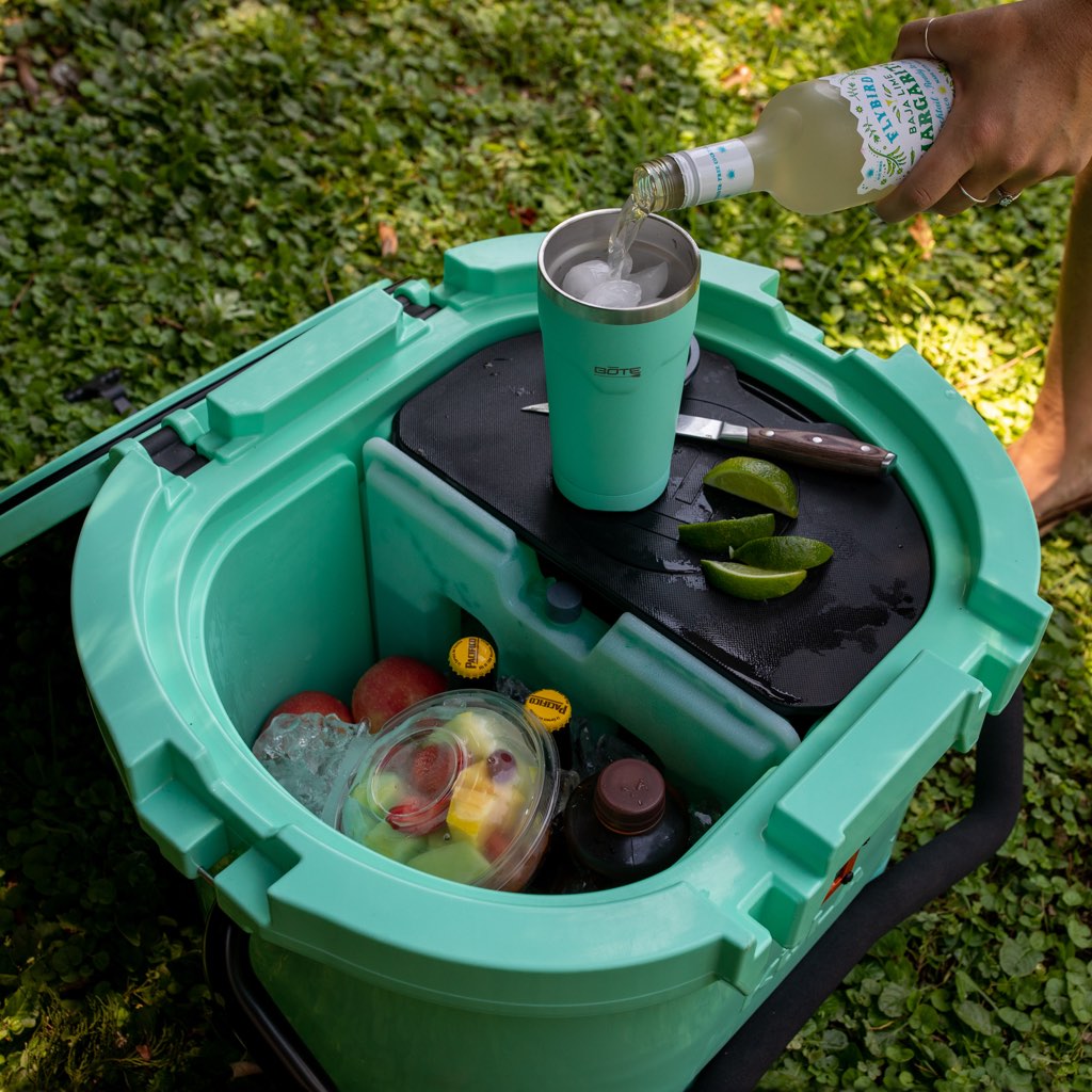 Person pouring drink in Bote tumbler on top of Kula 10 cooler