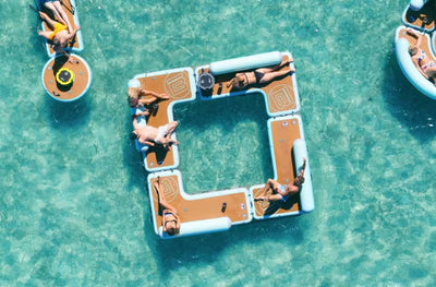 Top-down view of four Hangout Couches in clear blue water.