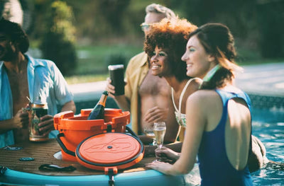 Friends surround the KULA Bar in a pool while enjoying drinks.