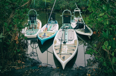 Four Rackham GS in a waterway near shore surrounded by trees.