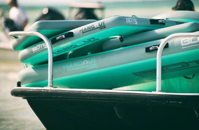 Stacked inflatables secured on a boat, showing durable design and compact storage.