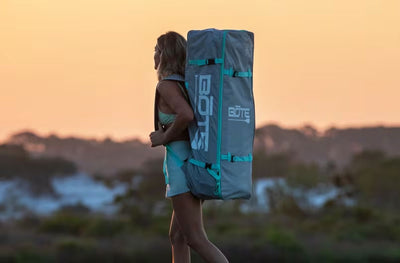 Person carrying a BOTE backpack with a scenic background
