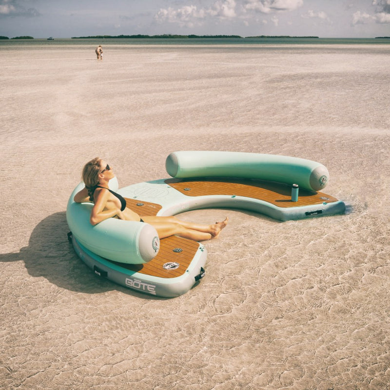 A woman sitting on the Inflatable Dock Hangout 240 Classic