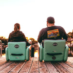 Man and woman sitting on their dock in their Aero Chairs, woman sitting in the Aero chair and man sitting in the Aero Chair XL