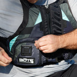 Close-up of man adjusting the front pocket on the BOTE Adult Fishing Foam PFD Vest in navy and teal.