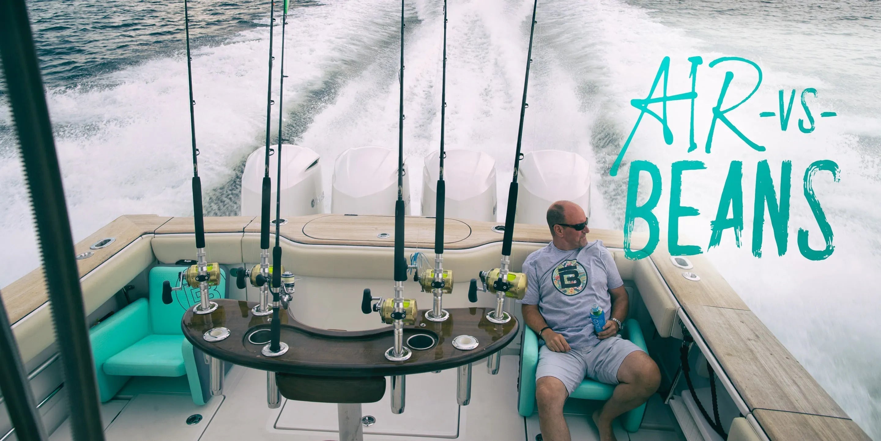 Man sitting on the back of a boat enjoying a drink sitting on an inflatable BOTE chair with multiple fishing rods stacked up ready to go.