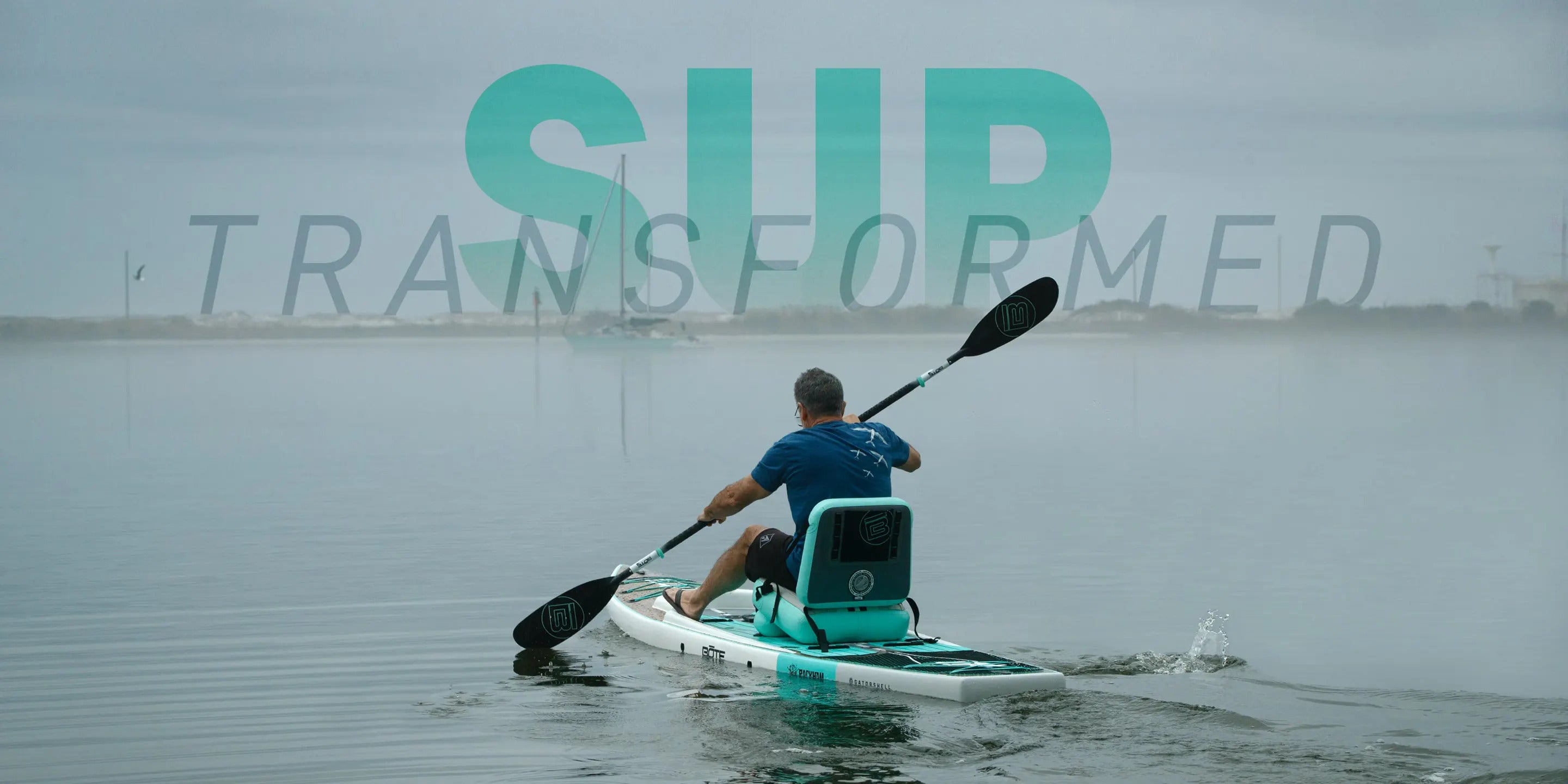 Paddleboarder paddling on calm water seated with the inflated seat transforming their paddleboard into a kayak with the works S"SUP Transformed"
