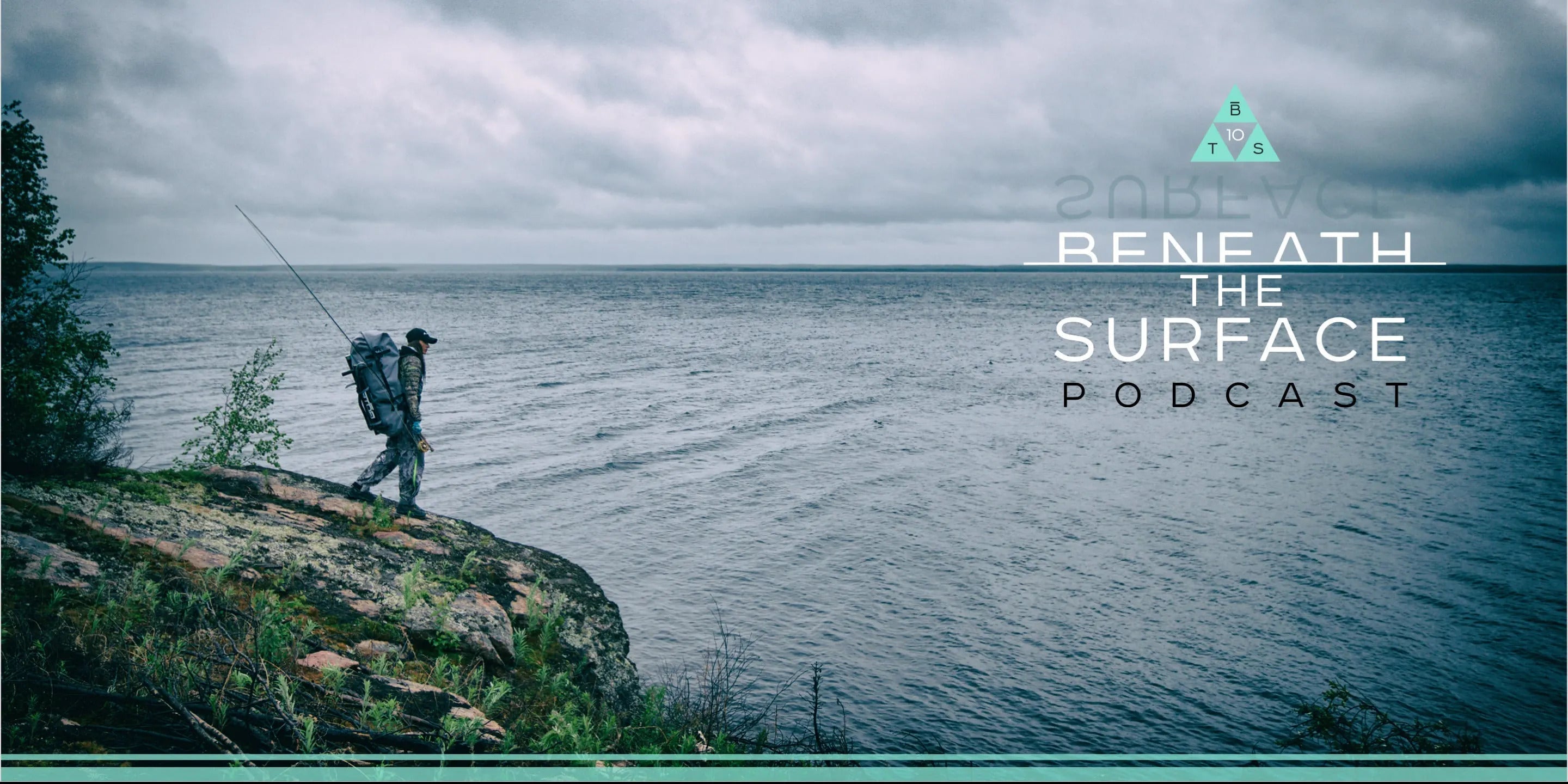 Fisherman walking on a rocky shore with a large pack, fishing gear and clouds in the sky, text overlay saying " Beneath the surface podcast"