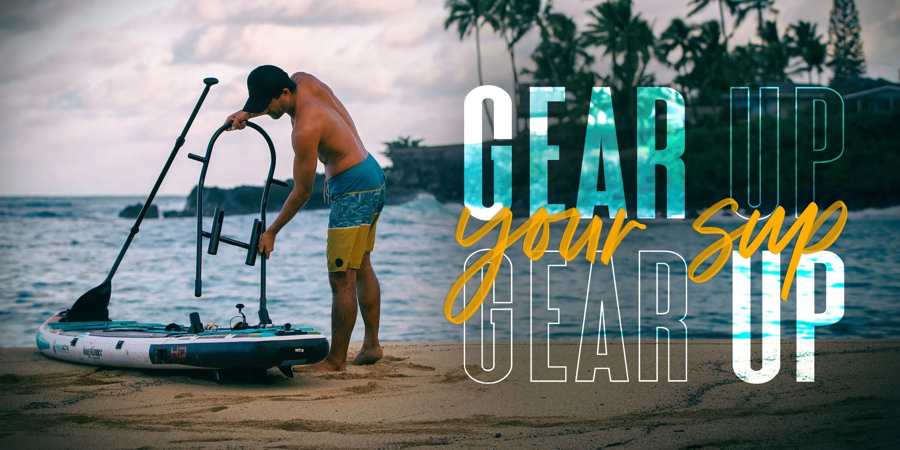 Man attaching a gear rack to a paddle board on the beach.