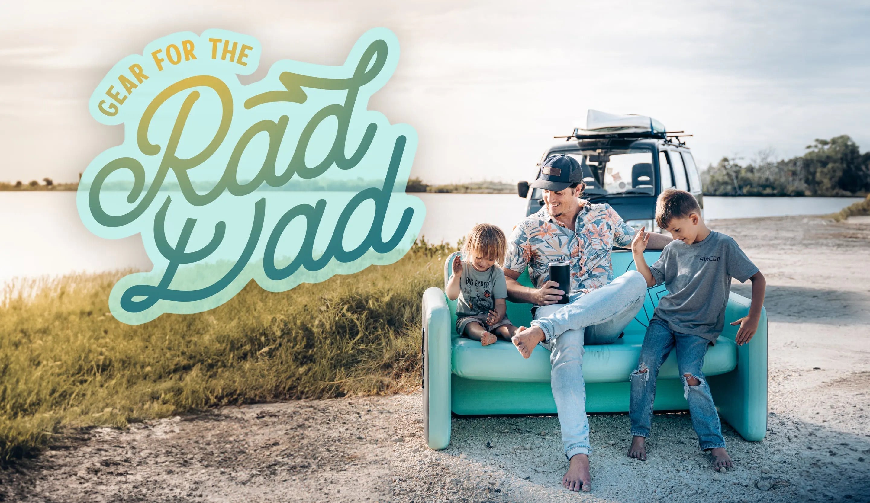 Dad with two kids sitting on an inflatable couch in front of his van on the beach.