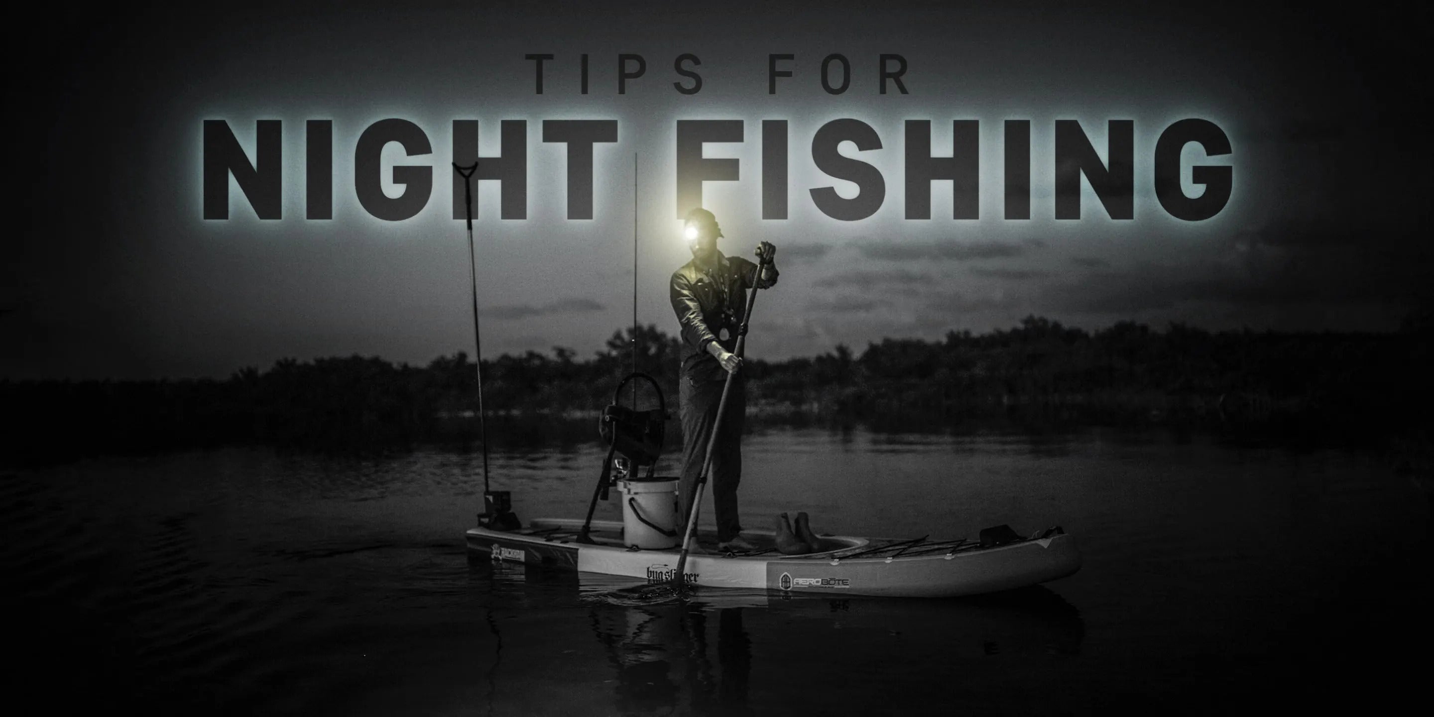 Paddleboarder on the water at night wearing a head lamp going out for an adventure. The words " Tips for night fishing" are overlayed