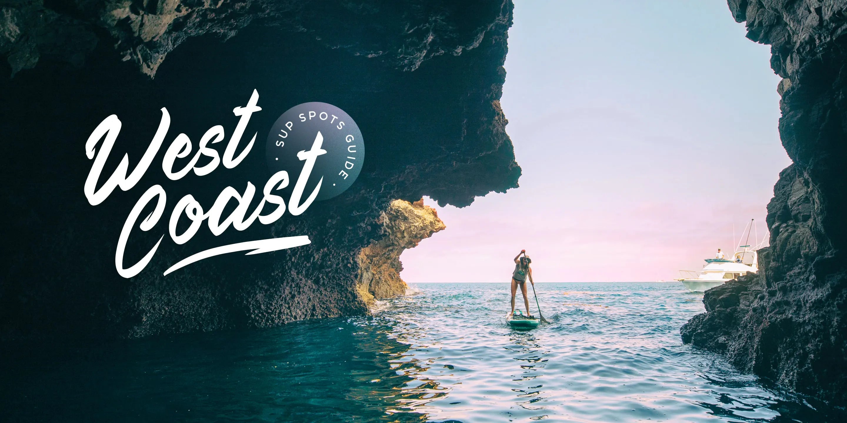 Paddle boarder paddling out through a large cave on calm ocean water with text overlay that says "West Coast : SUP spots guide"