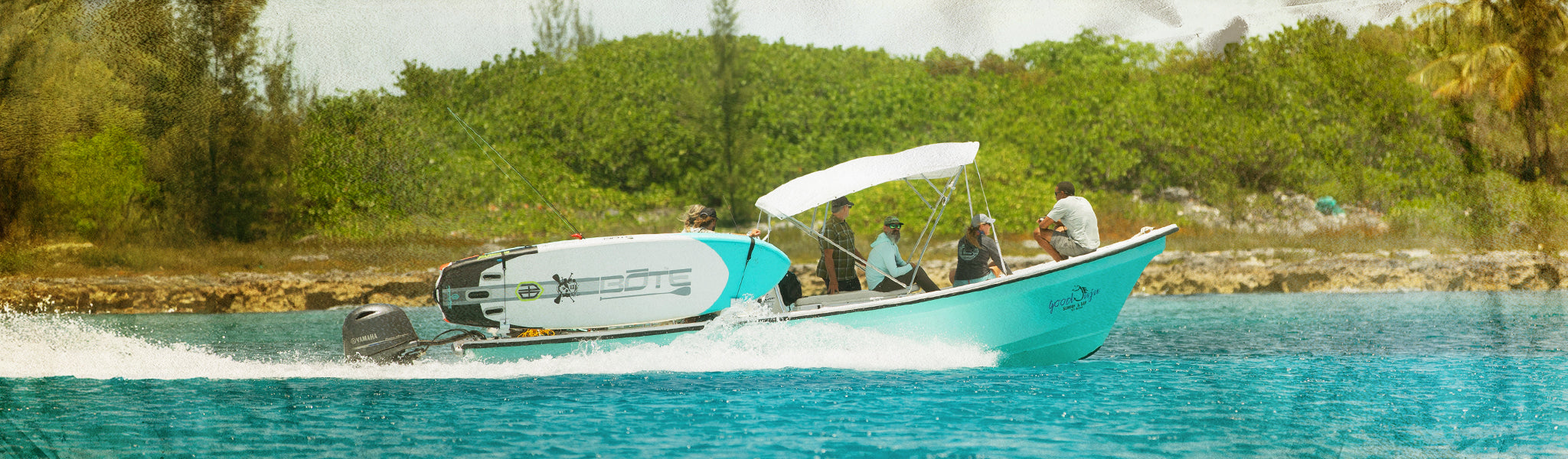 People on a boat in a body of water with trees in the background