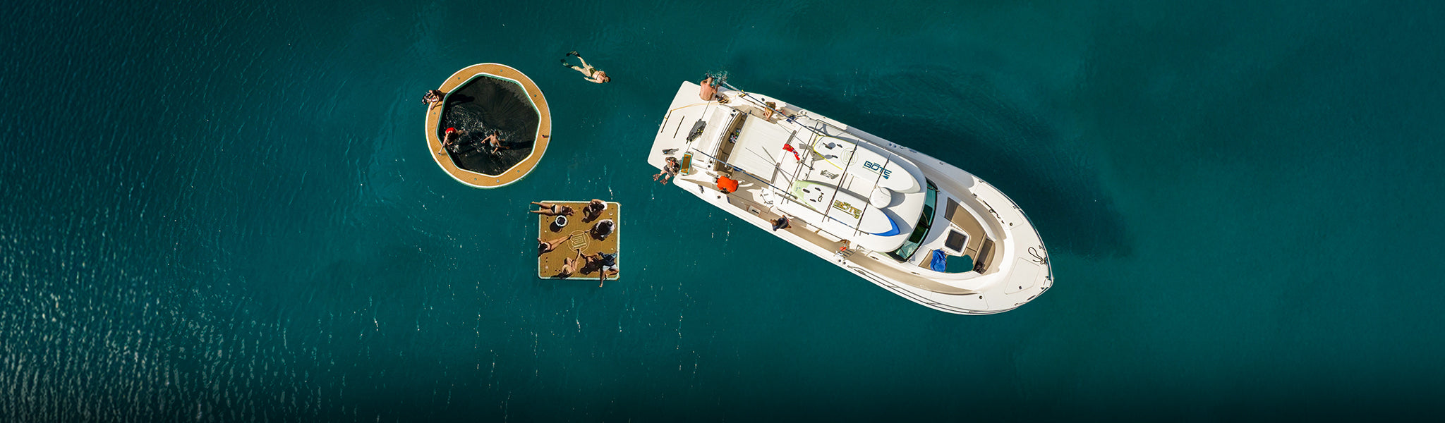 Overhead view of a boat near an inflatable dock and water hammock