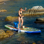A woman paddling on a HD Aero 11′6″ Native Nalu Inflatable Paddle Board