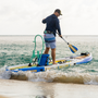 A guy standing on the Rackham Aero 12′4″ Native Fusion Apex Inflatable Paddle Board near the shoreline