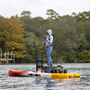 A person catching a fish on a Rover 14′ Fischer Cutthroat Micro Skiff