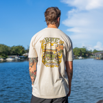 Back view of a guy wearing a BOTE Board Meeting Tee while looking out over the water