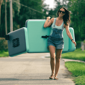 Woman carrying the Aero Couch with one hand while walking down the sidewal