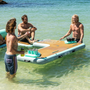 Two guys playing BOTE Pong Classic on a BOTE inflatable hangout couch.