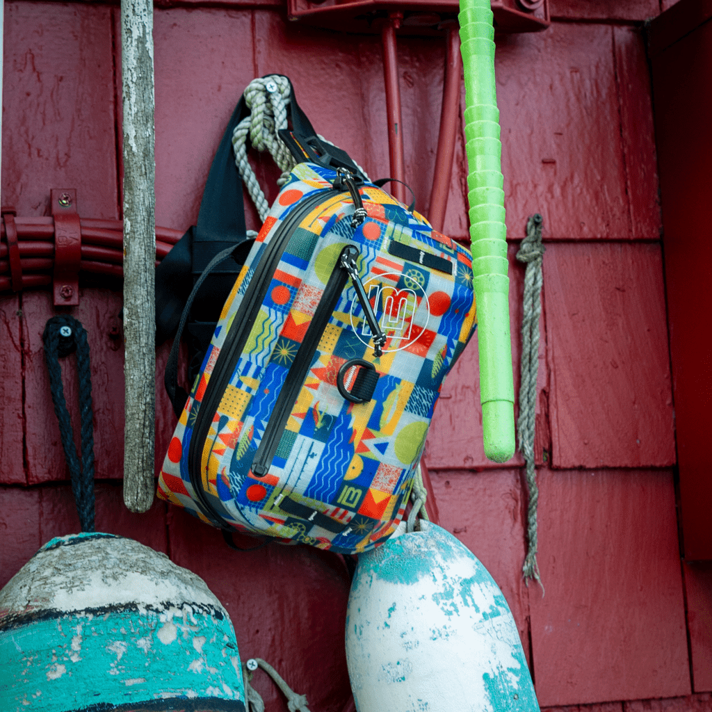 A Highwater Belt Pack Fischer Topwater hanging on a screw on the side of a wall