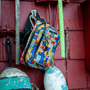 A Highwater Belt Pack Fischer Topwater hanging on a screw on the side of a wall
