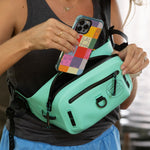 Highwater Belt Pack Seafoam worn at the waist, phone being placed in front zip pocket.
