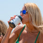 A woman drinking from a MAGNEChill Can Cooler Switch White