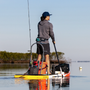 A guy paddling on a paddle board with graphite tackle rac on it