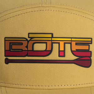 Closeup of a yellow, orange, and red BOTE logo on the front of Yellow panel hat