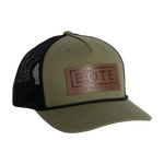 Front view of the BOTE Boxed Logo Hat with brown Patch in dark green.