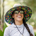 Person smiling wearing the BOTE Native Cuda Straw Hat with Hawaiian print design on the underside of the brim and a black drawstring.