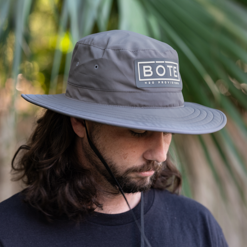 Person wearing the gray BOTE Boxed Logo Boonie Performance Hat with Patch