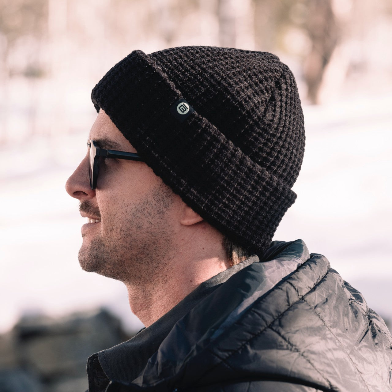 Side view of person wearing the BOTE Circle B Logo Beanie in Black