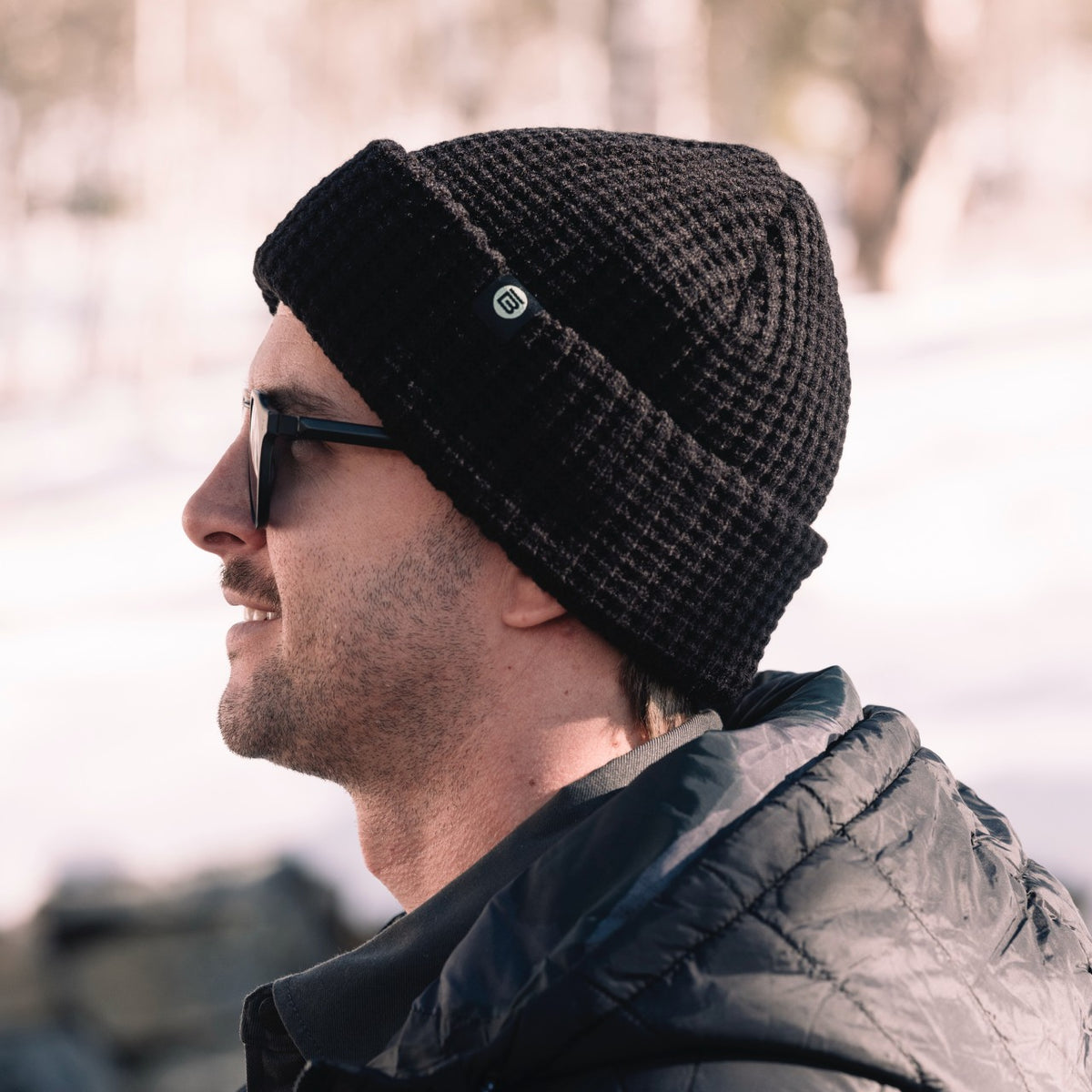 Side view of person wearing the BOTE Circle B Logo Beanie in Black