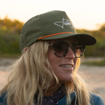 A person wearing a BOTE Fischer Snapback Hat