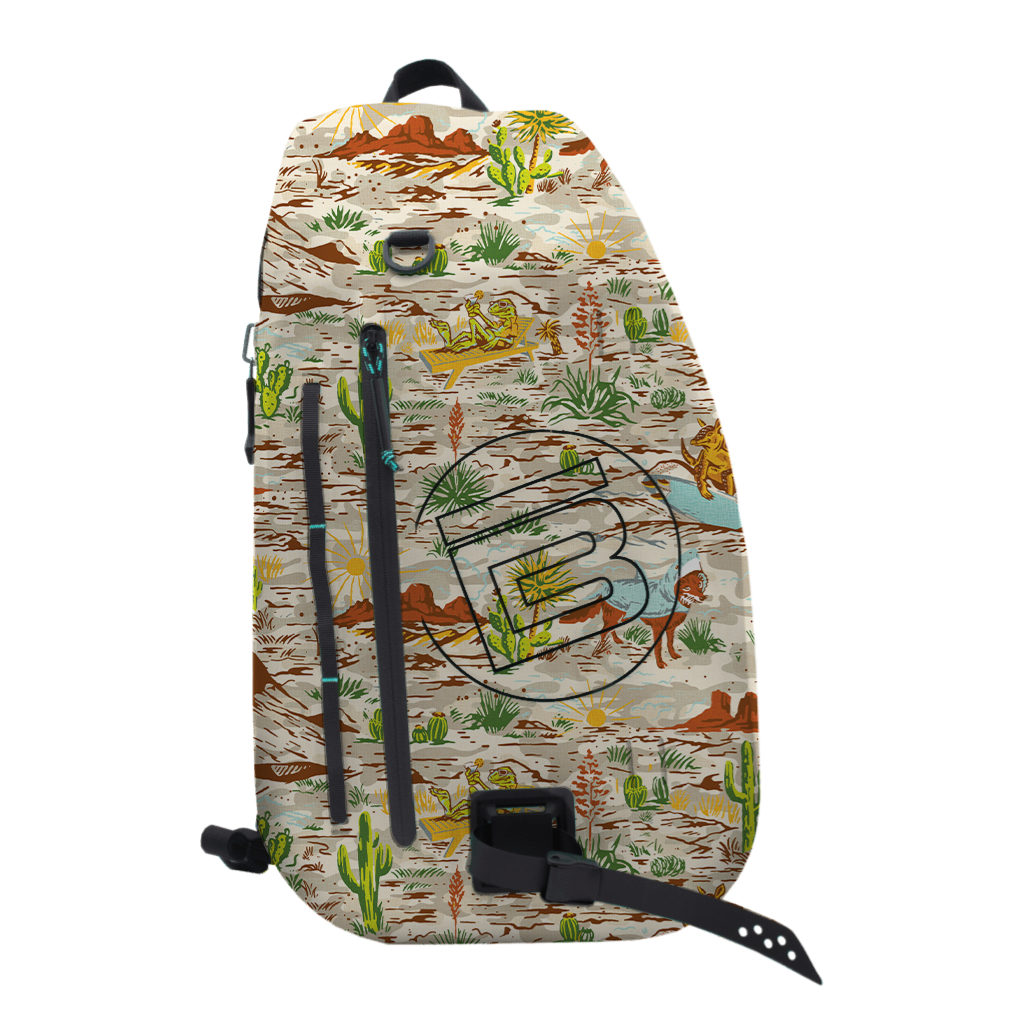 Front view of Highwater Slingpack Native Sendero with desert landscape and bold B logo.