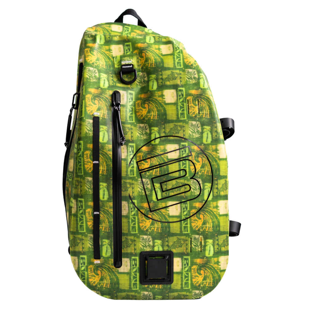 Highwater Slingpack in green pattern with front zip pocket, grab handle, and side straps.