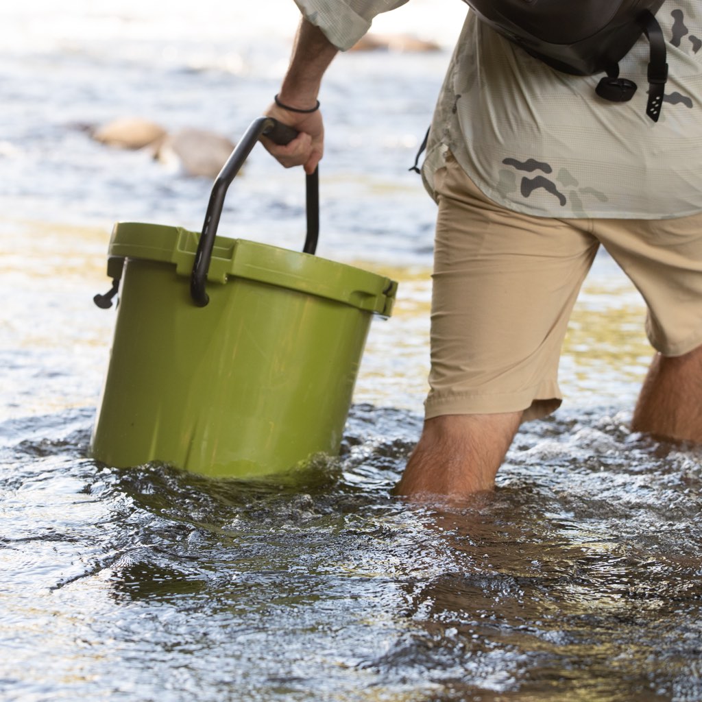 Man holding Kula 5 walking through water
