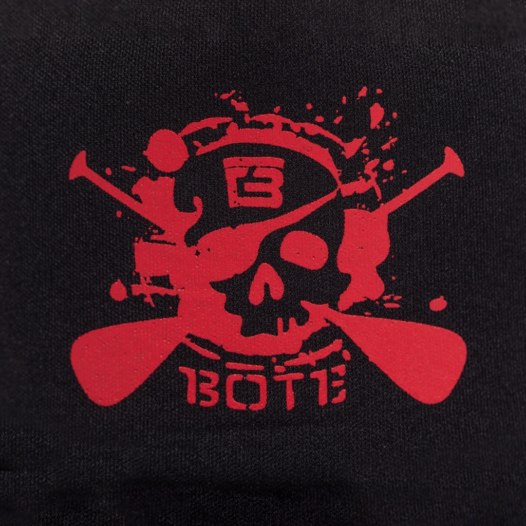 Closeup of red No Quarter Trucker Hat  with black background.