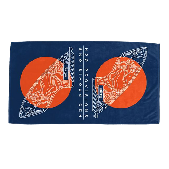 BOTE Fin Woven Towel laid flat, showing navy background with orange sun circles and white fin line art.